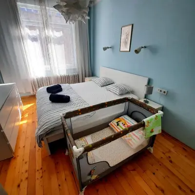 a bedroom with a bed in a room with blue walls at Cozy & Stylish apartment in the heart of Sofia in Sofia
