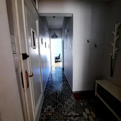 a hallway with a door and a tile floor at Cozy & Stylish apartment in the heart of Sofia in Sofia