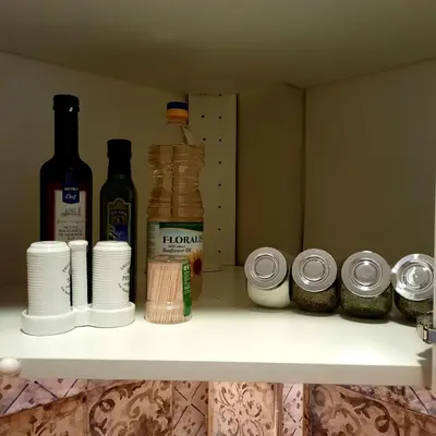 a shelf with bottles of alcohol and other spices at Cozy & Stylish apartment in the heart of Sofia in Sofia