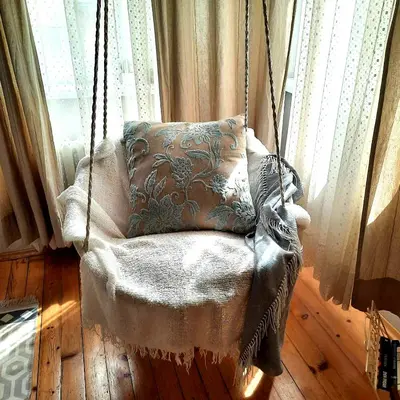 a swinging chair with a pillow in a room at Cozy & Stylish apartment in the heart of Sofia in Sofia