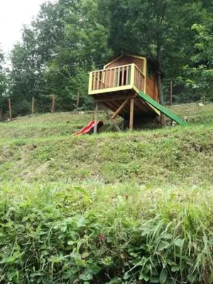 a tree house sitting on top of a hill at 