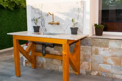 a wooden sink with potted plants on it at Допълнителна къща за гости Ози 2 in Ovchartsi