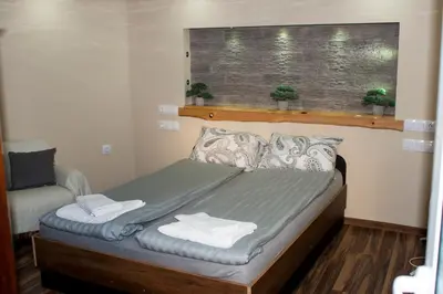 a bedroom with a bed with two towels on it at Допълнителна къща за гости Ози 2 in Ovchartsi