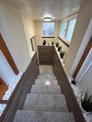 a staircase in a home with rocks and windows at Допълнителна къща за гости Ози 2 in Ovchartsi