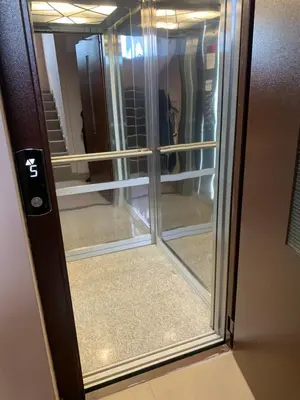 a glass door with a reflection of a closet at Pazardzhik suite home in Pazardzhik