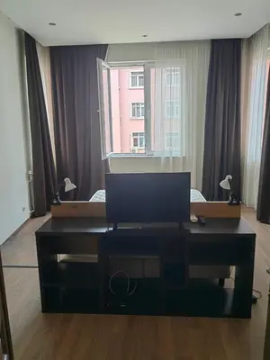 a desk with a laptop computer on it in a room at Vitosha 67 in Sofia