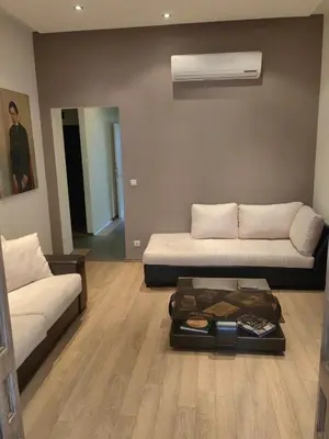 a living room with a couch and a coffee table at Vitosha 67 in Sofia