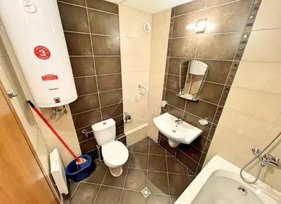 a small bathroom with a toilet and a sink at Aspen Luxury Apartamnet in Razlog