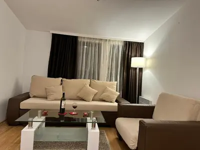 a living room with a couch and a glass table at Aspen Luxury Apartamnet in Razlog
