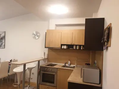 a kitchen with a sink and a stove top oven at Aspen Luxury Apartamnet in Razlog