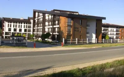 a building on the side of a road next to a street at Aspen Luxury Apartamnet in Razlog