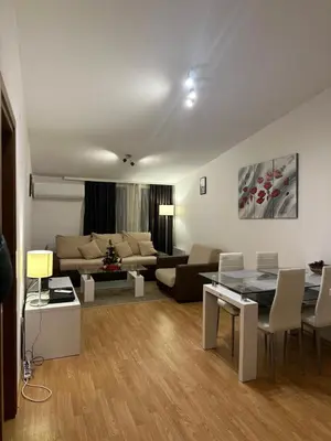 a living room with a couch and a table at Aspen Luxury Apartamnet in Razlog
