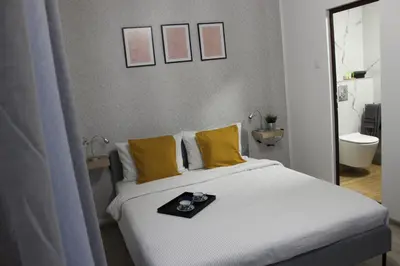 a bed with yellow pillows and a tray on it at Orange House in the Old Town Plovdiv- free parking in Plovdiv