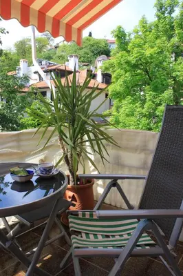 a table and chairs on a patio with a plant at Orange House in the Old Town Plovdiv- free parking in Plovdiv