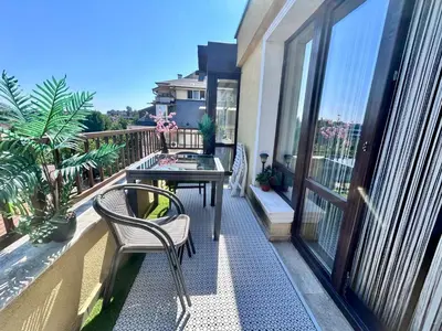 a balcony with a table and chairs on a balcony at Vitosha Terrace 1BR Apartment with Parking in Sofia