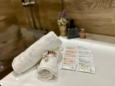 a bathroom with a towel and two packages of soap at Vitosha Terrace 1BR Apartment with Parking in Sofia
