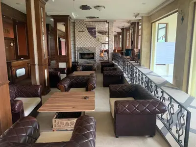 a restaurant with couches and a table and chairs at Panorama Bansko in Bansko