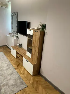 a living room with a tv and a wooden table at Lux apartments Top center in Sofia