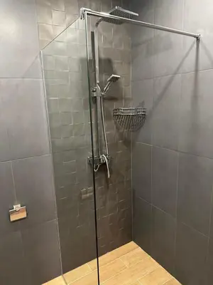 a shower with a glass door in a bathroom at Lux apartments Top center in Sofia