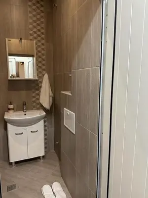 a small bathroom with a sink and a mirror at Lux apartments Top center in Sofia