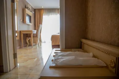 a bedroom with a bed and a dining room at Luxury Apartment 'Rich' in Velingrad