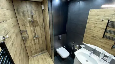 a bathroom with a toilet and a sink at Deluxe Studio 200m from Ski Road in Bansko