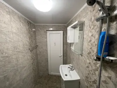 a bathroom with a sink and a mirror and a shower at Еделвайс Edelvais in Kostenets Village