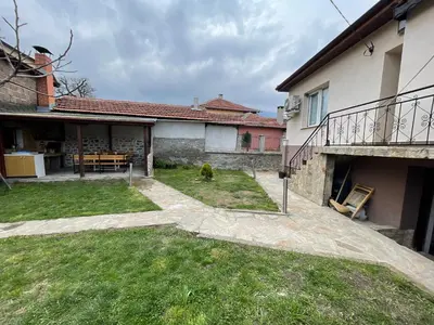 a backyard of a house with a dog in the yard at Еделвайс Edelvais in Kostenets Village