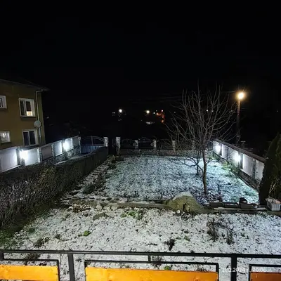 a snow covered street at night with a building at Еделвайс Edelvais in Kostenets Village