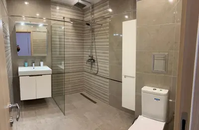 a bathroom with a shower and a toilet and a sink at Apartment Mladost 2 - Free Parking in Sofia