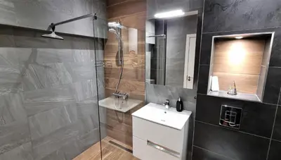 a bathroom with a shower and a sink and a mirror at Luxury Quiet Apartment in the City Center in Plovdiv