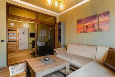 a living room with a couch and a table at Eagles' Bridge - 1BD Flat with Desk by Flat Mаnager in Sofia