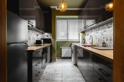 a kitchen with green walls and stainless steel appliances at Eagles' Bridge - 1BD Flat with Desk by Flat Mаnager in Sofia