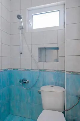 a bathroom with a toilet and a shower with a window at Eagles' Bridge - 1BD Flat with Desk by Flat Mаnager in Sofia