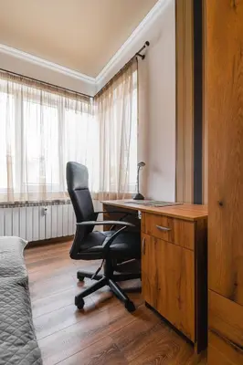 a bedroom with a desk and a chair next to a bed at Eagles' Bridge - 1BD Flat with Desk by Flat Mаnager in Sofia
