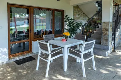 a white table and chairs on a patio at Къща за приятели Недкови in Vasil Levski