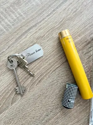 a yellow pen and keys on a wooden floor at Flower house 8 in Sofia