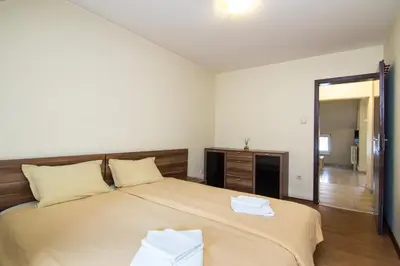 a bedroom with a large bed with two towels on it at Family Hotel Madrid in Sofia