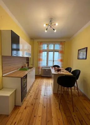 a kitchen with a table and chairs in a room at CityPulse Apt in Ideal Center w Working Space in Sofia