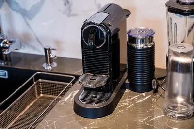 a blender sitting on a counter next to a sink at Sofia Paradise View Apartment in Sofia