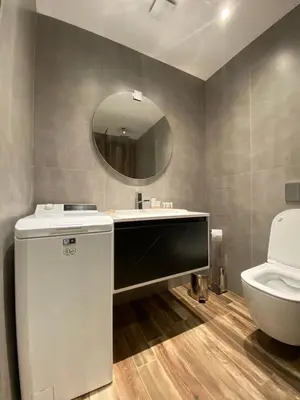a bathroom with a sink and a toilet and a mirror at Sofia Paradise Lux Apartment in Sofia