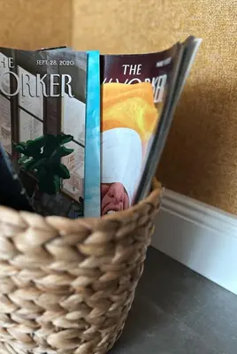 a basket filled with magazines sitting on a table at Contemporary Charm in Old Sofia in Sofia