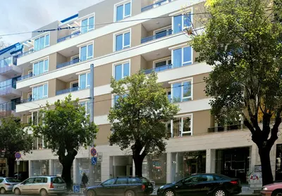 a large building with cars parked in front of it at Heart of Sofia Studio in Sofia