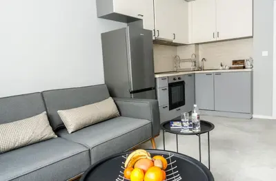 a living room with a couch and a table with fruit on it at COOP Apartments, Sofia - Free Parking in Sofia