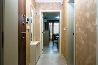 a hallway with a door leading to a dining room at COOP Apartments, Sofia - Free Parking in Sofia