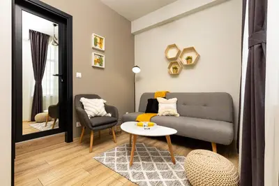 a living room with a couch and a table at Kapana Guest House on Central Pedestrian street with Parking included in Plovdiv
