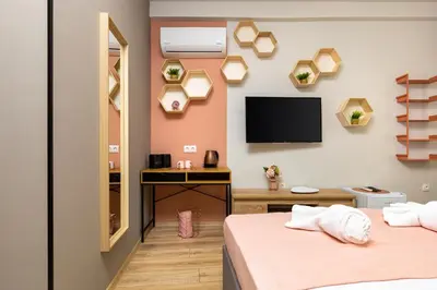 two beds in a room with a tv on the wall at Kapana Guest House on Central Pedestrian street with Parking included in Plovdiv