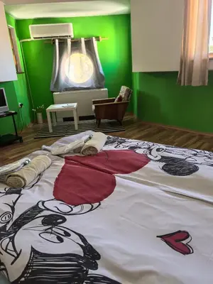 a large bed in a room with green walls at 4 Rooms in Plovdiv