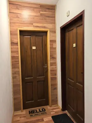 two doors in a room with wooden walls at 4 Rooms in Plovdiv