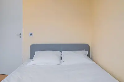 a bed with two white pillows in a room at The Honeycomb Hideaway by Flat Mаnager in Sofia